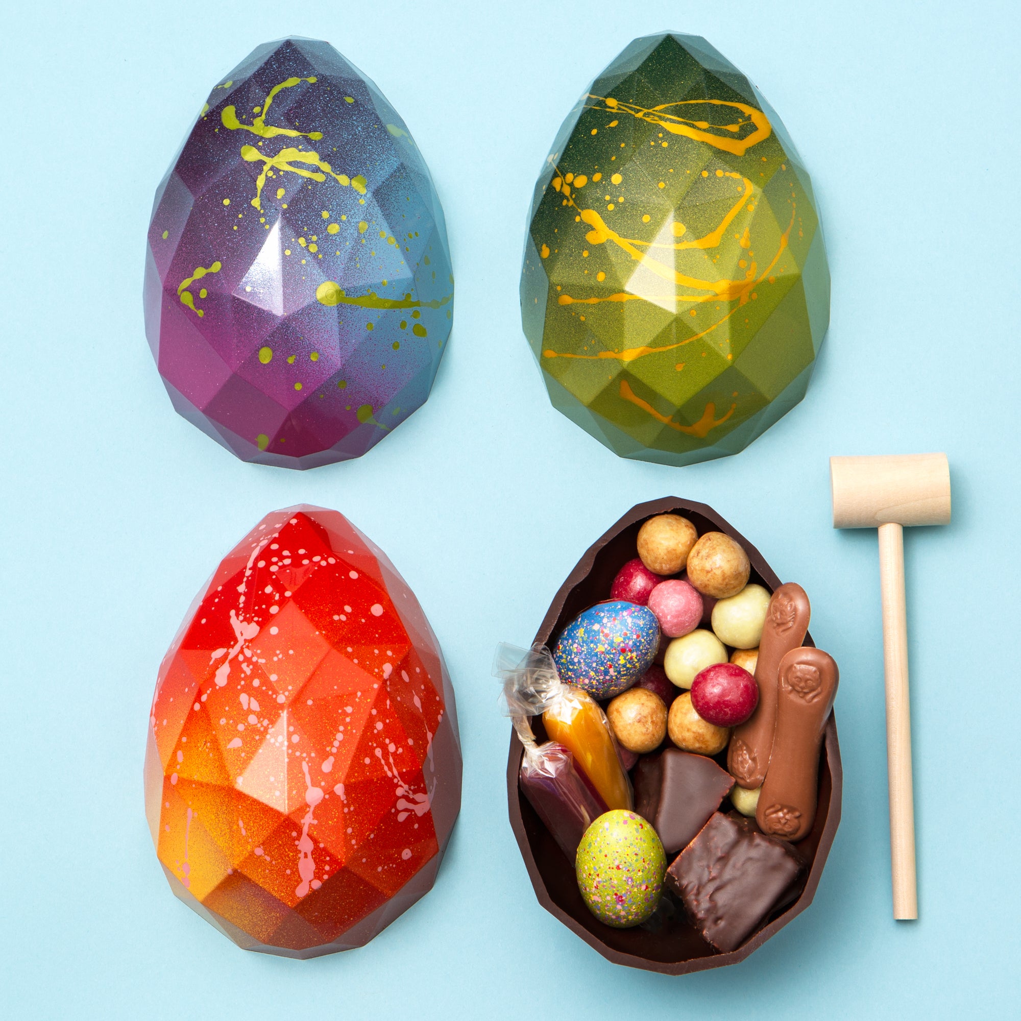 Colourful Easter Eggs with goods inside and small wooden hammer provided.